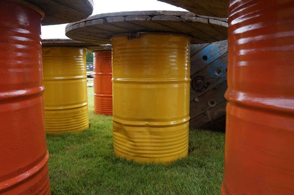 Tables made by the volunteers from painted barrels and wooden cable reels