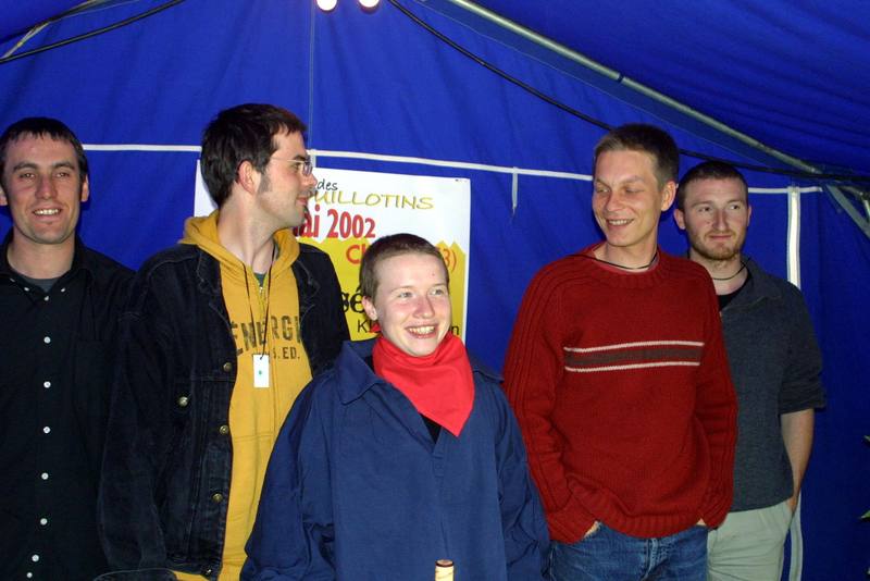 Des membres de l'équipe devant l'affiche du festival 2002 - photo AMAC / Les Mouillotins