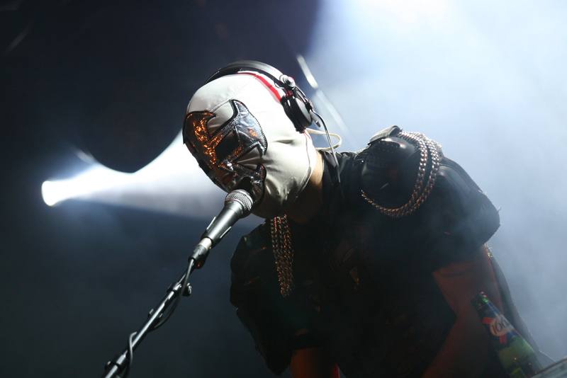Un chanteur masqué dans un halo de lumière blanche - photo AMAC / Les Mouillotins